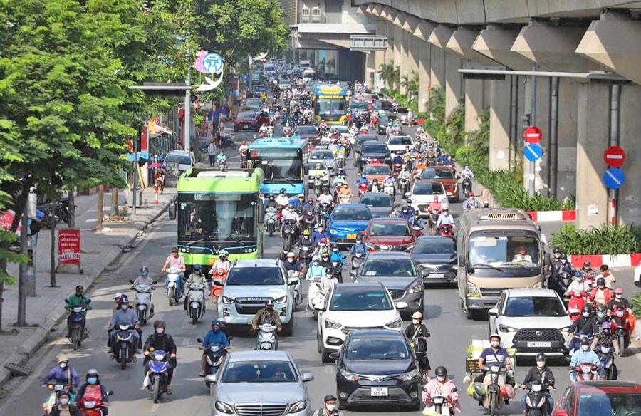 Busy Vietnamese street filled with motorbikes and traffic chaos.